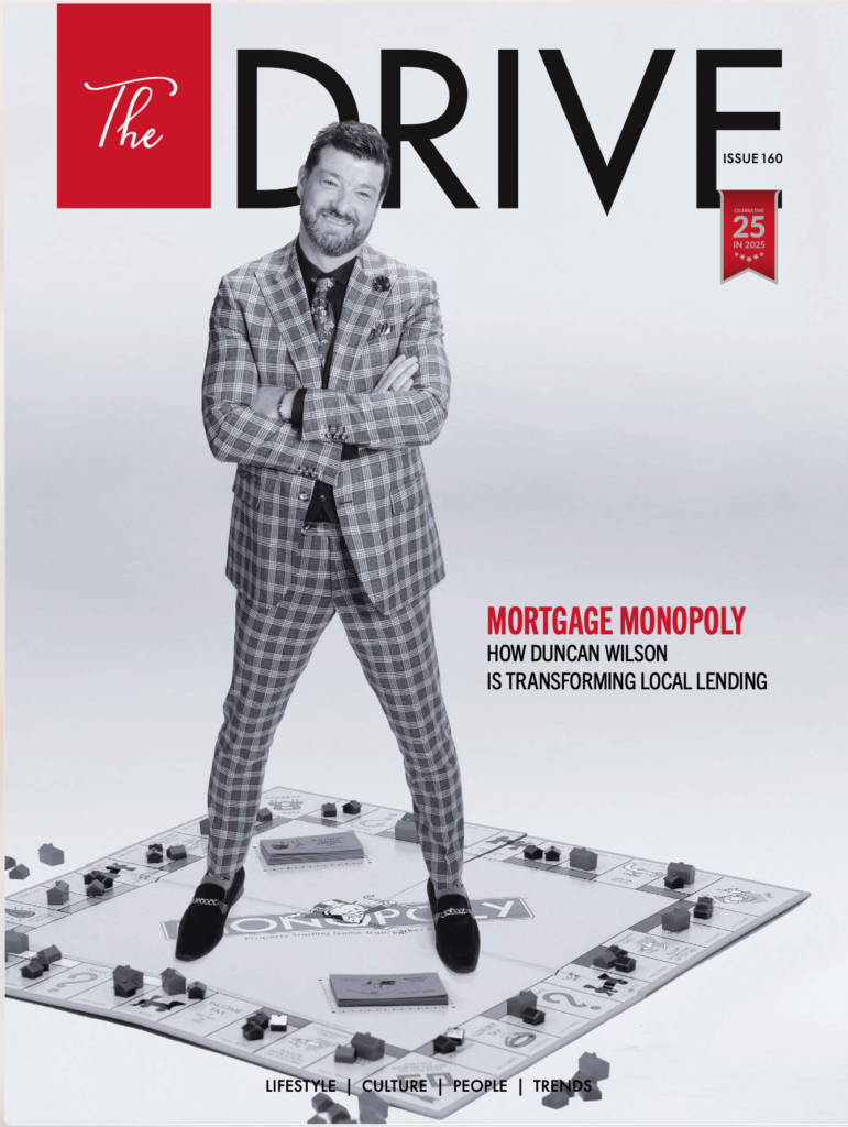 Duncan Wilson standing on a Monopoly board
